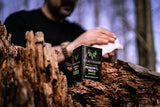 field wipes in 10 ct with a background that shows a hunter cleaning his hand in the forest with the field wipes