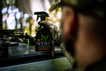 A man looking and holding the scent blocker spray
