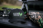 Scent Assassin full skull logo hunting hat with hunting spray and hunting apparel alongside it